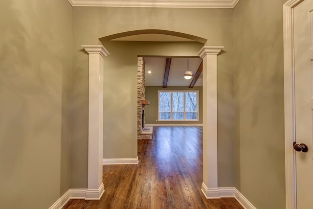 hall featuring ornamental molding, ornate columns, beamed ceiling, and dark hardwood / wood-style flooring