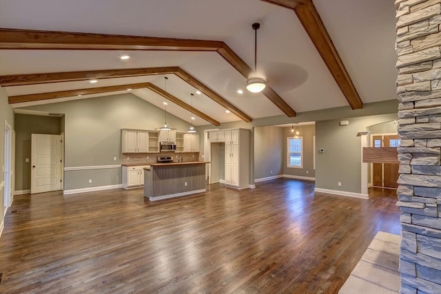 unfurnished living room featuring vaulted ceiling with beams, ceiling fan with notable chandelier, and dark wood-type flooring