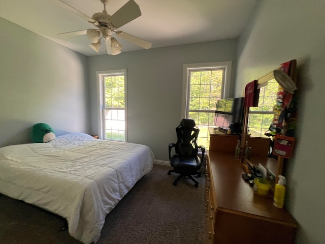 carpeted bedroom with ceiling fan and multiple windows