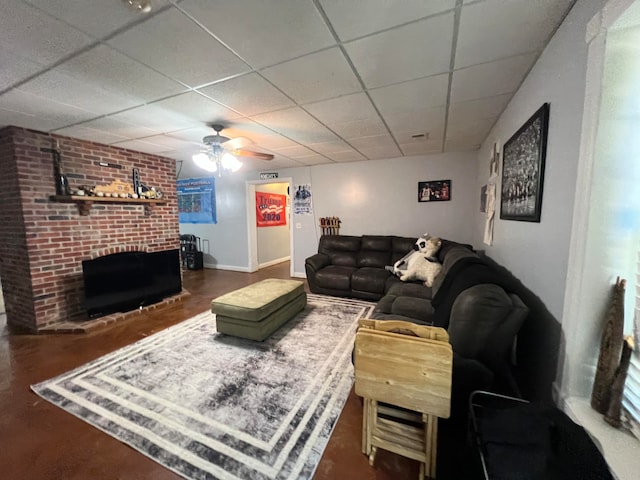 living room featuring a paneled ceiling, a fireplace, and ceiling fan