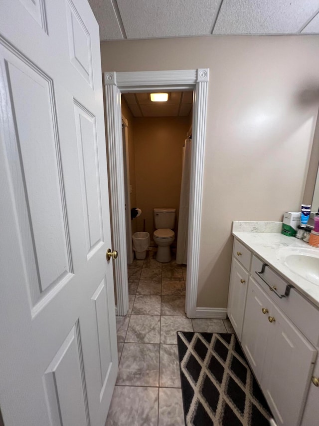 bathroom featuring tile patterned flooring, vanity, and toilet