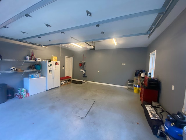 garage with fridge, a garage door opener, and white refrigerator with ice dispenser