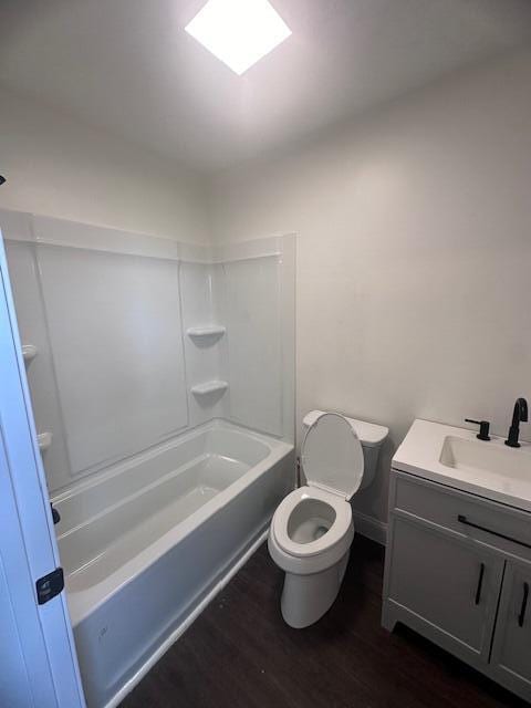 full bathroom featuring vanity, toilet,  shower combination, and hardwood / wood-style flooring