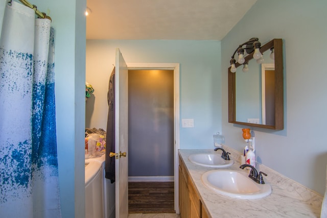 bathroom with hardwood / wood-style flooring and vanity