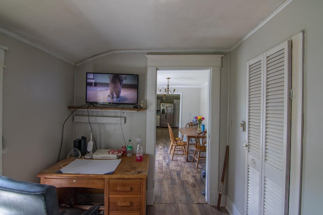 office space with crown molding, hardwood / wood-style floors, vaulted ceiling, and an inviting chandelier