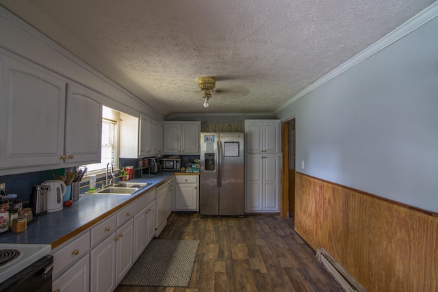 kitchen with appliances with stainless steel finishes, dark wood-type flooring, white cabinets, ceiling fan, and sink