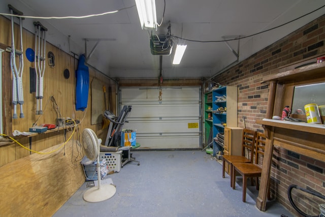 garage with a garage door opener and a workshop area