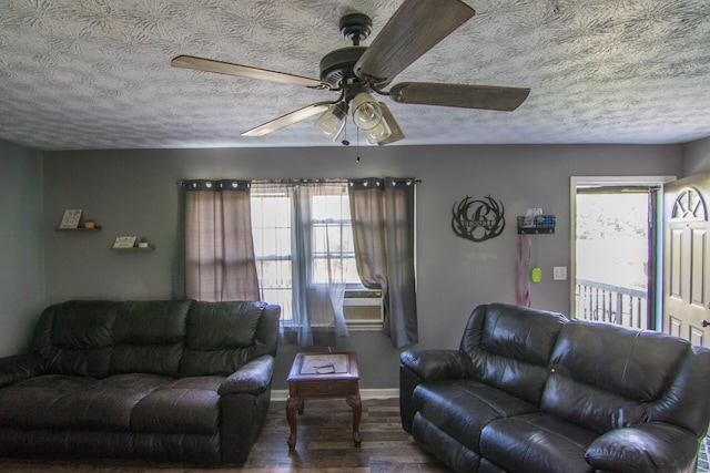 living room with a textured ceiling, hardwood / wood-style flooring, ceiling fan, and a wealth of natural light