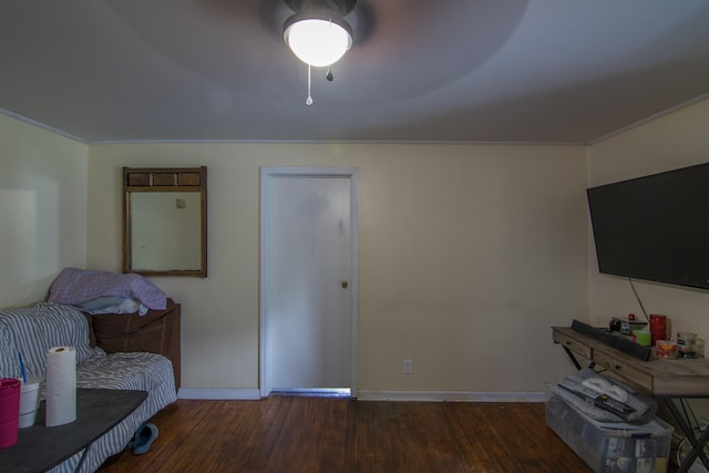 interior space featuring crown molding, dark hardwood / wood-style flooring, and ceiling fan