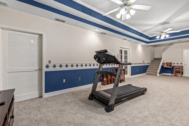 exercise room with ceiling fan, carpet floors, and ornamental molding