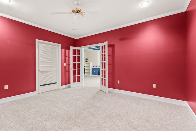 spare room featuring french doors, crown molding, carpet flooring, and ceiling fan