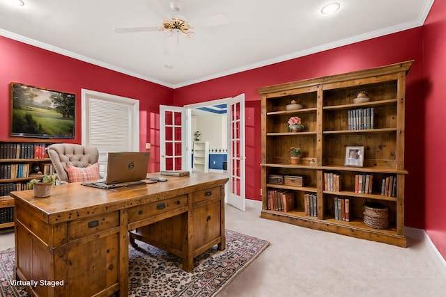 carpeted home office featuring french doors, crown molding, and ceiling fan