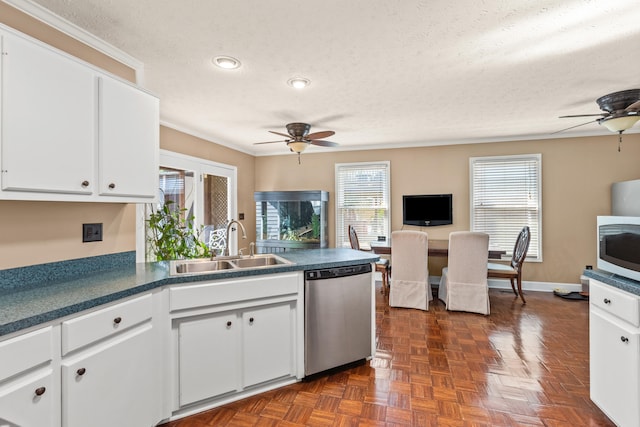 kitchen with sink, white cabinetry, stainless steel dishwasher, and a textured ceiling