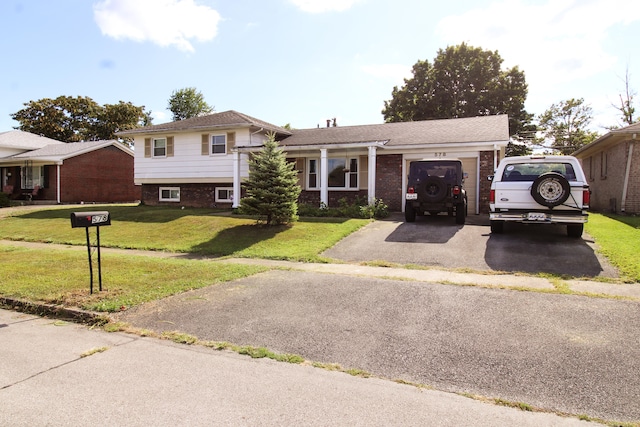 split level home featuring a garage and a front lawn