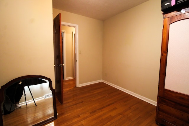 bedroom featuring dark hardwood / wood-style flooring