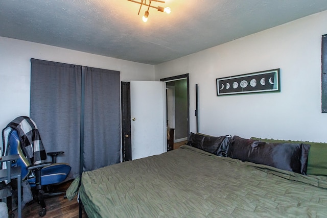 bedroom featuring a textured ceiling and hardwood / wood-style floors