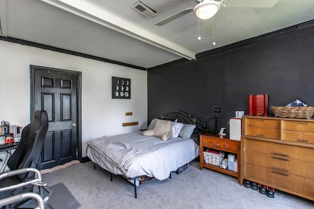 bedroom with ceiling fan, beamed ceiling, carpet flooring, and a textured ceiling