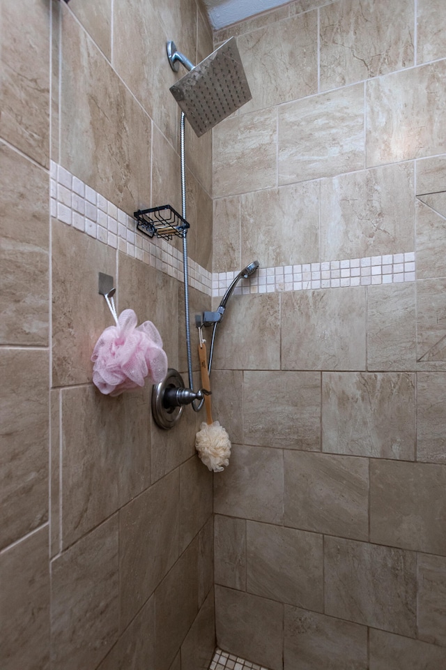 interior details with a tile shower