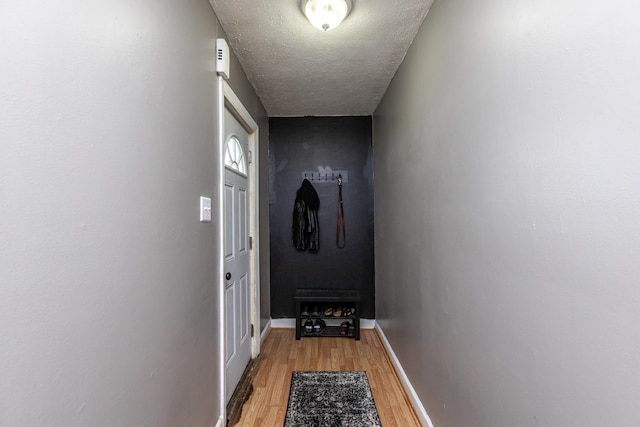 entryway featuring a textured ceiling and hardwood / wood-style floors