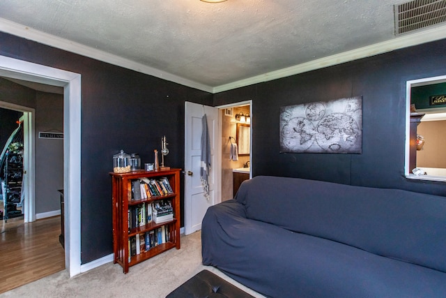 carpeted living room featuring a textured ceiling and crown molding