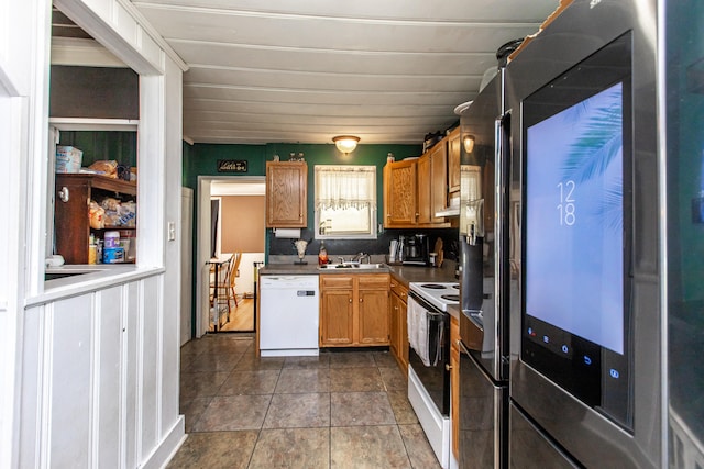 kitchen with white appliances, sink, and exhaust hood