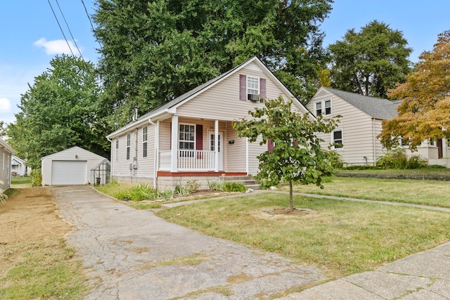 view of front of house with a front yard, a porch, a garage, and an outdoor structure