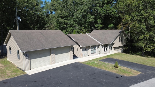 view of front of property with a garage and a front lawn