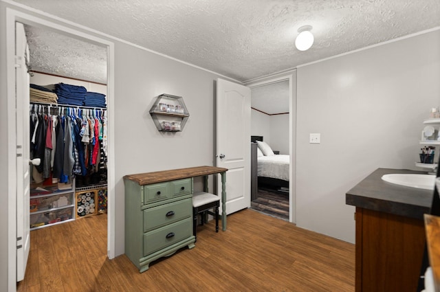 bathroom featuring vanity, hardwood / wood-style floors, and a textured ceiling