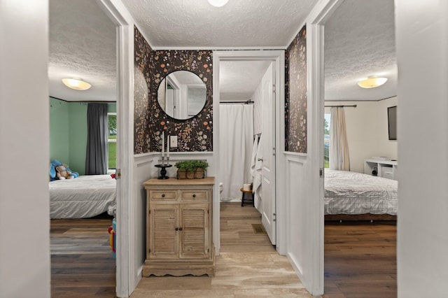 interior space with light hardwood / wood-style floors and a textured ceiling