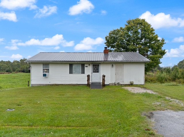 single story home with cooling unit and a front lawn