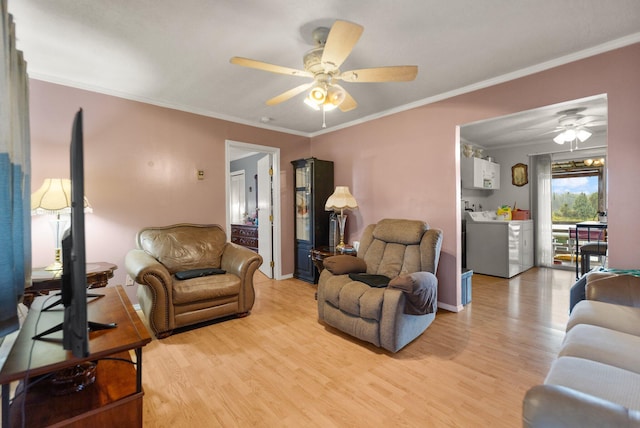 living room featuring light wood-type flooring, washer / clothes dryer, and ceiling fan