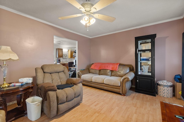 living room with ceiling fan, ornamental molding, and light hardwood / wood-style floors