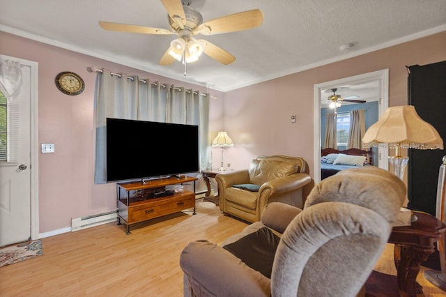 living room featuring baseboard heating, light wood-type flooring, crown molding, a textured ceiling, and ceiling fan