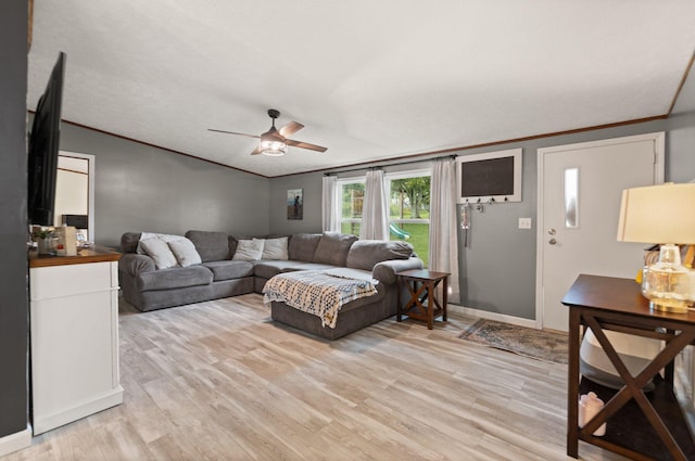 living room with crown molding, light hardwood / wood-style floors, and ceiling fan