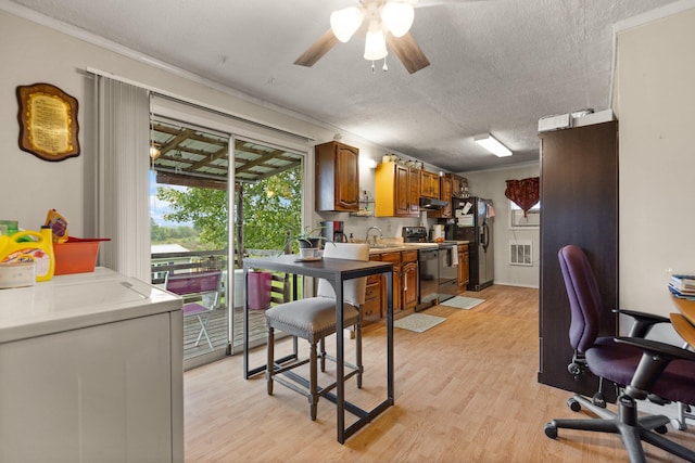 kitchen with light hardwood / wood-style floors and a textured ceiling