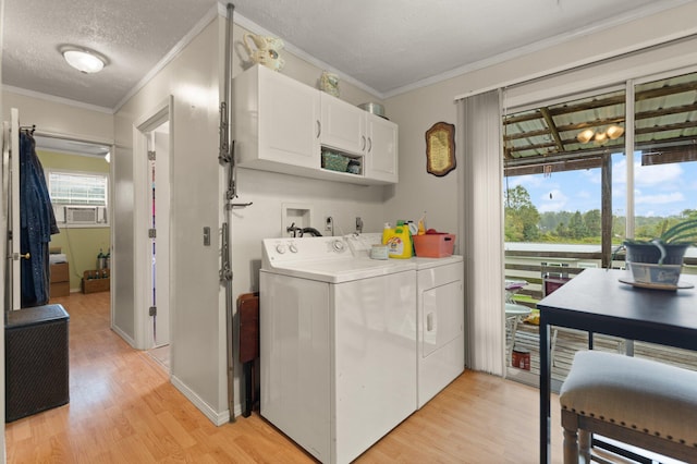 laundry area featuring light hardwood / wood-style floors, independent washer and dryer, a textured ceiling, crown molding, and cabinets