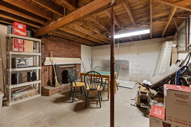 basement featuring a brick fireplace