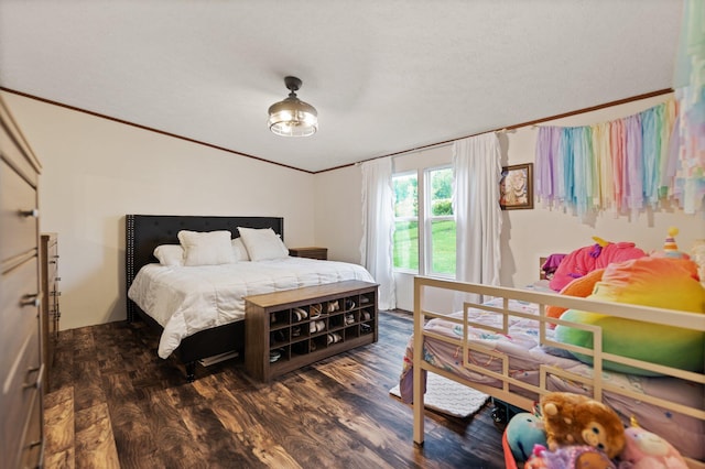 bedroom with ornamental molding and dark hardwood / wood-style floors