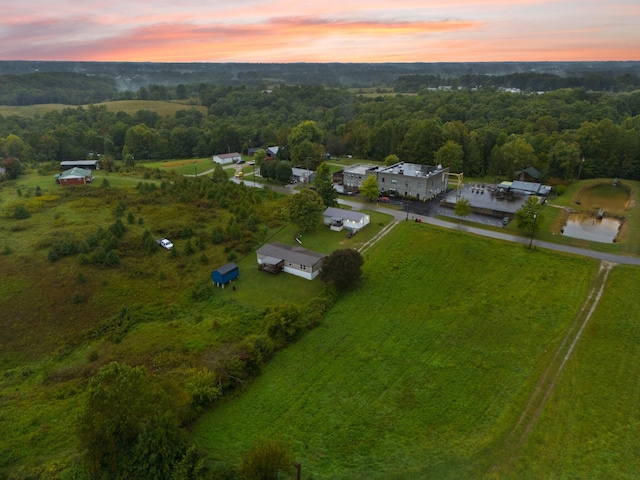 aerial view at dusk featuring a rural view