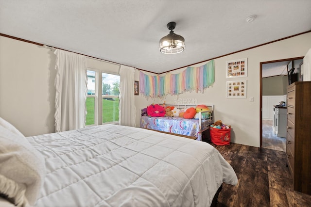 bedroom with a textured ceiling, ornamental molding, and hardwood / wood-style flooring