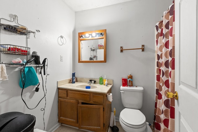 bathroom with vanity, a shower with curtain, toilet, and tile patterned floors