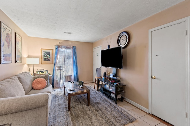 tiled living room with a textured ceiling