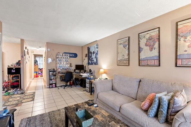 living room with a textured ceiling, built in desk, and light tile patterned floors