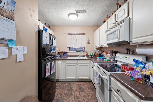 kitchen with sink, white cabinetry, a textured ceiling, and white appliances