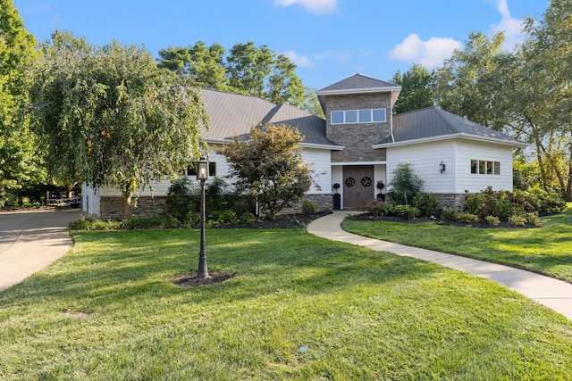 view of front of property with a garage and a front yard