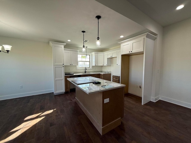 kitchen featuring white cabinetry, recessed lighting, dark wood-style floors, and a kitchen island