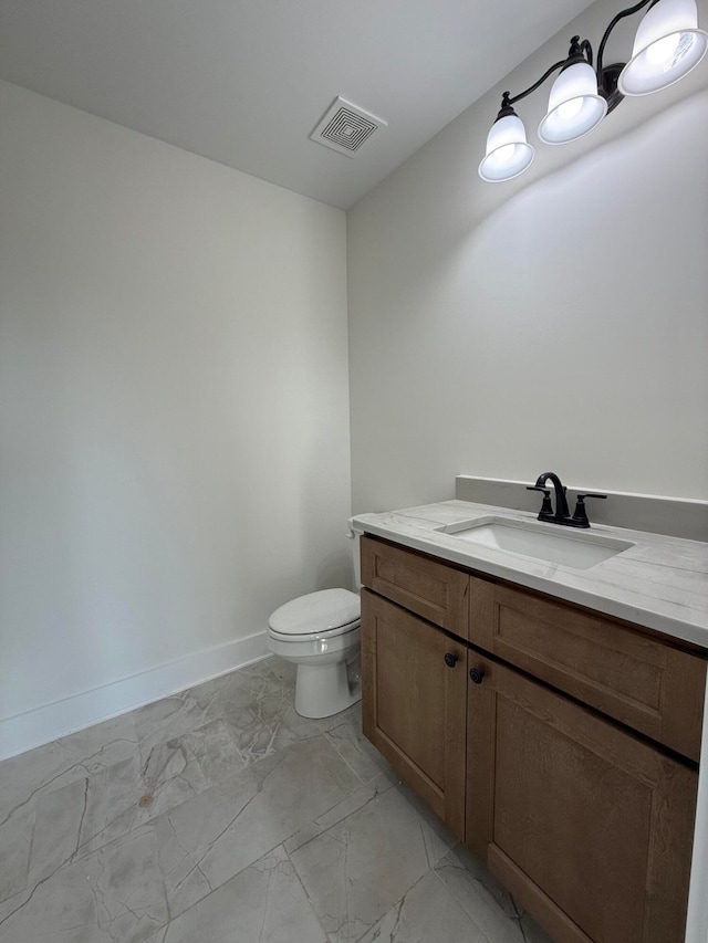 bathroom featuring visible vents, baseboards, toilet, marble finish floor, and vanity