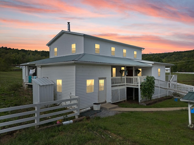 back house at dusk with a yard