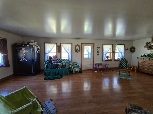 unfurnished living room with dark hardwood / wood-style flooring and plenty of natural light