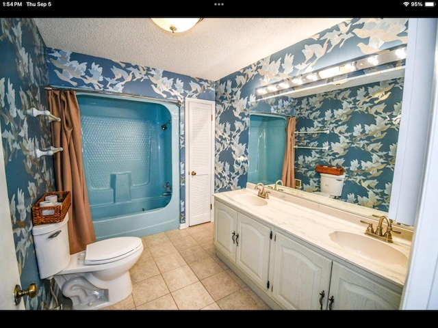 full bathroom with a textured ceiling, tile patterned flooring, vanity, and toilet